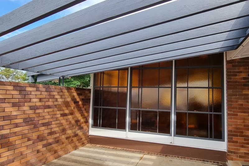 A Brisbane courtyard and original pergola, the kind of outdoor work that still has to clear a council desk.